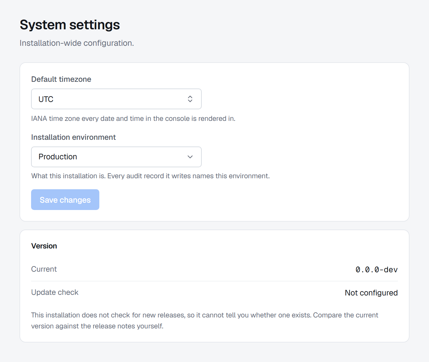 Settings › System: the default time zone (UTC) and the installation environment (Production) above a greyed-out Save changes, then the version it is running, with the update check not configured and a note that the installation cannot tell whether a newer release exists.