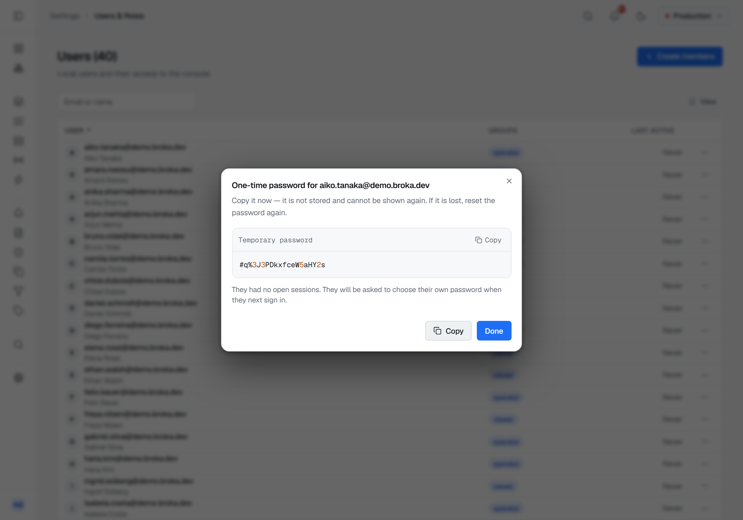 The one-time password dialog for aiko.tanaka@demo.broka.dev: a twenty-character temporary password with a Copy button, a line saying it is not stored and cannot be shown again, and a note that the account had no open sessions and will be asked to choose its own password at the next sign-in.