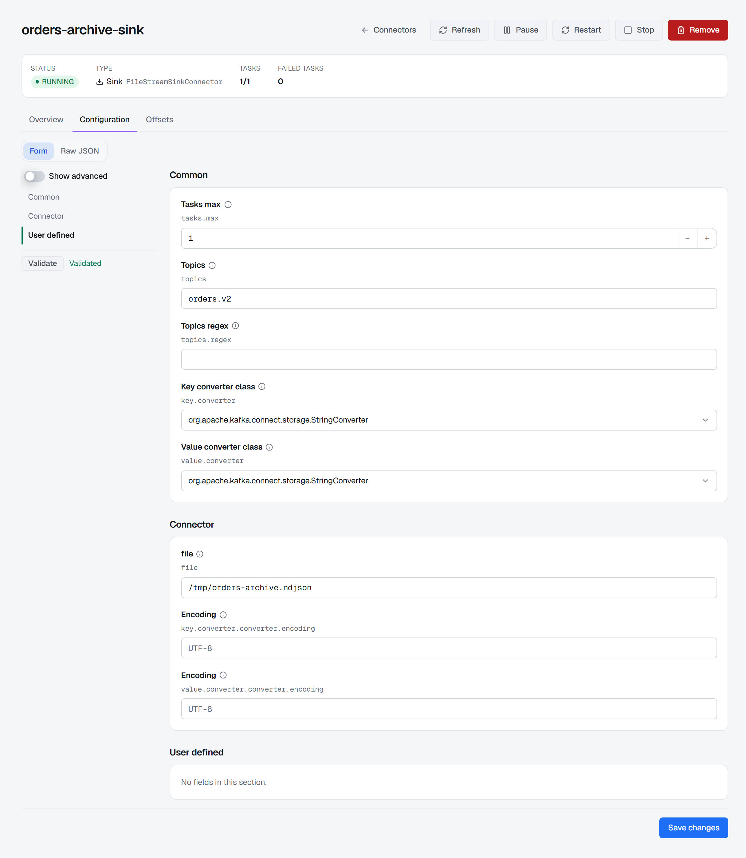 The Configuration tab of orders-archive-sink, a RUNNING FileStreamSinkConnector with 1/1 tasks and 0 failed, in its Form view: a group rail of Common, Connector and User defined beside Show advanced and Validate, reading Validated; the Common group holds Tasks max 1, Topics orders.v2, an empty Topics regex and the StringConverter key and value converters, the Connector group holds the file /tmp/orders-archive.ndjson and two UTF-8 encodings, and Save changes sits at the bottom.